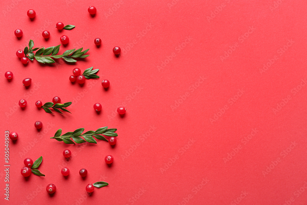 Ripe lingonberries with leaves on red background