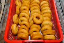 Morning Breakfast With Mini Donuts On Red Basket  Wooden Background. Tasty Donuts Closeup. Doughnut