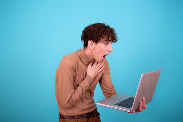 Cheerful funny student with a laptop.