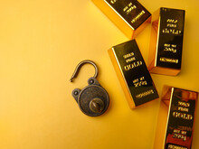 Vintage Padlock With Gold Bar On A Yellow Background.