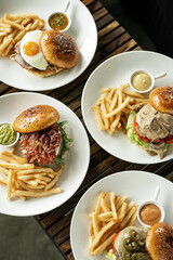 Wall Mural - Various gourmet burgers selection on restaurant wood table