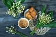 cup of coffee and lilies of the valley on wooden background