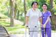© Timeimage - Asian female nurse taking care of a middle-aged female patient in the park