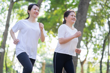 Image of Asian mother and daughter exercise at park