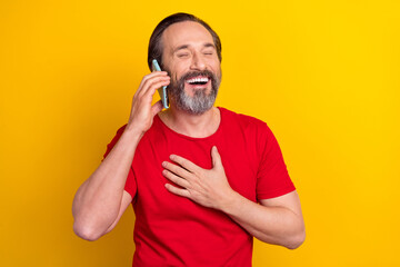 Sticker - Photo of attractive funky guy pensioner dressed red t-shirt talking modern device laughing isolated yellow color background