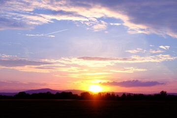 sunset in evening beautiful dramatic sky with cloud, background light sky gradient, concept of heavenly space, abode of God, meditative calmness and greatness, black silhouette of hills at bottom