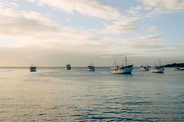 Wall Mural - Photographs of beaches of Margarita Nueva Esparta in the morning and at sunset. You can see mountains, sun, clouds, sun rays, sunset, beaches, ships, boats, people fishing, rocks, waves, mist,