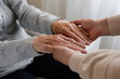 © Evrymmnt - Mature female in elderly care facility gets help from hospital personnel nurse. Cropped shot of senior woman's hands with aged wrinkled skin and care giver. Background, copy space, close up.