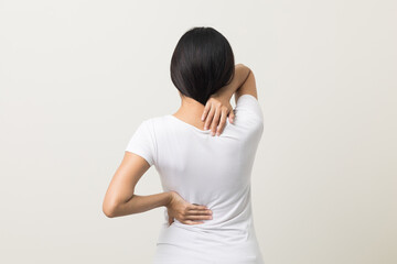 Asian woman has problem with structural posture She had neck and back pain. She massaged her neck and shoulders for relief. reduce muscle tension. Standing on isolated white background