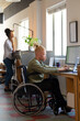 © Wavebreak Media - African american disable albino mid adult businessman on wheelchair using laptop at desk in office