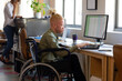 © Wavebreak Media - African american albino mid adult businessman sitting on wheelchair while working on laptop at desk