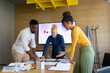 © Wavebreak Media - African american mid adult business people with albino colleague discussing in conference room