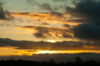 Sunset in springtime with golden light and stormy looking stratocumulus clouds. Kildare, Ireland