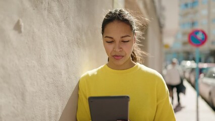 Poster - Young african american woman smiling confident using touchpad at street