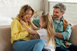 © Prostock-studio - Joyful Parents And Daughter Having Fun Laughing Sitting At Home