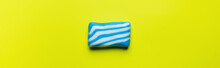 Top View Of Bath Soap With White And Blue Stripes On Yellow Background, Banner.