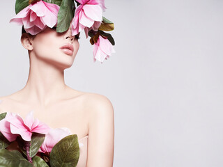  Fashion photo of a beautiful woman. Fashion model posing with flowers.  