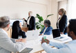 © PintoArt - senior woman boss in the office in a meeting with colleagues