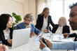 © PintoArt - group of people of different generations, in creative business office - multiracial business people working together -