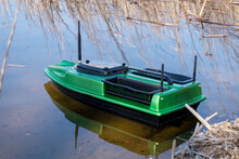 Bait Boat On Water. Wireless Remote Control Green Fishing Feeder, Fish Finder Boat. 