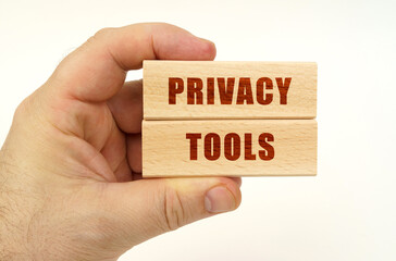 Poster - On a white background, a hand that holds wooden blocks with the inscription - Privacy Tools