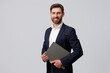 © Kostiantyn - Portrait of successful businessman with beard holding laptop. Studio shoot