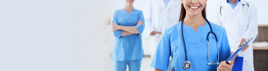 Canvas Print - Doctor in uniform with stethoscope at workplace, space for text. Banner design