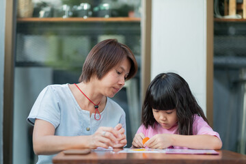 kid doing homework with mother, family concept, learning time, student, back to school