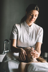 Wall Mural - Health, beauty, resort and relaxation concept. Beautiful woman in spa salon getting massage