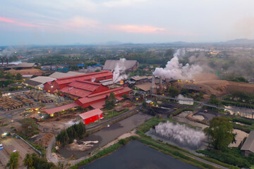 Aerial view of factory industry with smoke and toxic air from chimney in energy and pollution environment concept with city town landscape background.