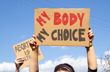 Protesters Holding Signs My Body My Choice And Abortion Is Healthcare. People With Placards Supporting Abortion Rights At Protest Rally Demonstration.