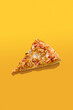 Slice of pizza over bright color background