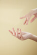 © Tuan  Nguyen  - A front view of hand posing in beige background for cosmetic advertising