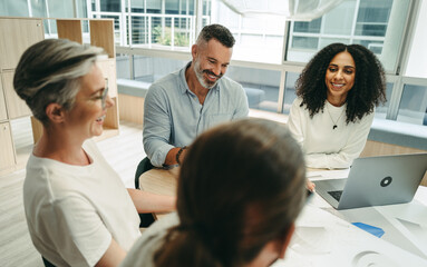 Happy businesspeople having a meeting in a co-working office