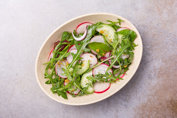 Wall Mural - Healthy vegetarian salad with fresh radish, cucumber, onion and mix of green leaves