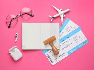 Sticker - Flat lay composition with passport, stamp and flight tickets on pink background