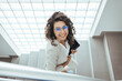 © Dragana Gordic - Portrait of a young businesswoman using a digital tablet while walking up a staircase in an office. Businesswoman walking upstairs and using touchpad. Business concept