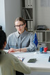 © AnnaStills - Vertical shot of unrecognizable woman applying for travel visa having appointment in embassy