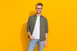 canvas print picture Portrait of attractive cheerful intelligent guy posing wearing specs isolated over bright yellow color background