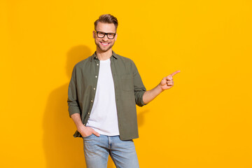 Sticker - Portrait of attractive cheerful lucky guy showing copy empty blank space ad isolated over bright yellow color background