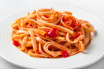 Wall Mural - Italian linguini pasta with tomato sauce close-up. Side view.