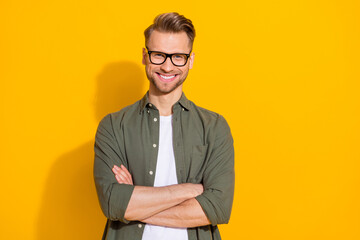 Wall Mural - Portrait of attractive cheerful content intellectual guy folded arms isolated over bright yellow color background