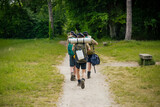 Fototapeta  - young scouts hiking in the countryside