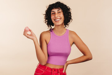 Wall Mural - Cheerful young woman holding a reusable sanitary cup