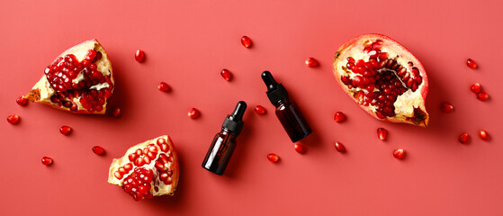 Amber glass dropper bottles with essential oils contains extract of pomegranate. Natural fruit aromatherapy oils.