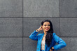 © Dani D.G - Cheerful ethnic woman in casual wear on street