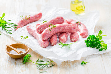 Poster - Raw sausages prepared for BBQ and grill with herbs and onions