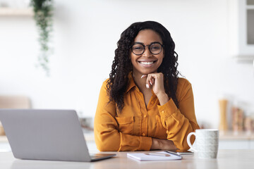 Portrait of beautiful black woman working on laptop