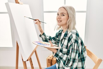 Sticker - Young artist student girl smiling happy painting at art studio.