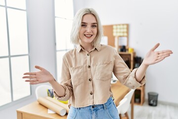 Sticker - Young beautiful caucasian woman at construction office looking at the camera smiling with open arms for hug. cheerful expression embracing happiness.